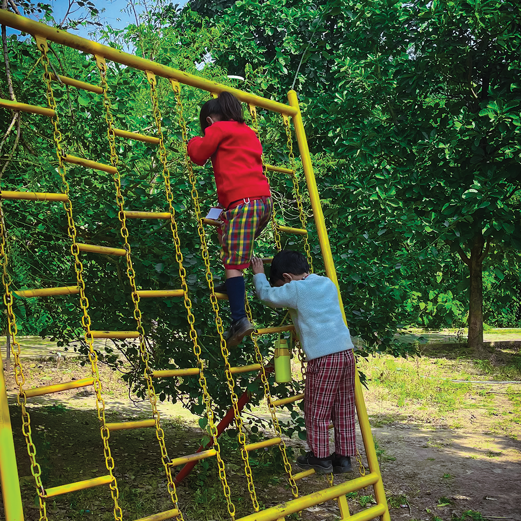 Large sandbox filled with colorful toys and shovels