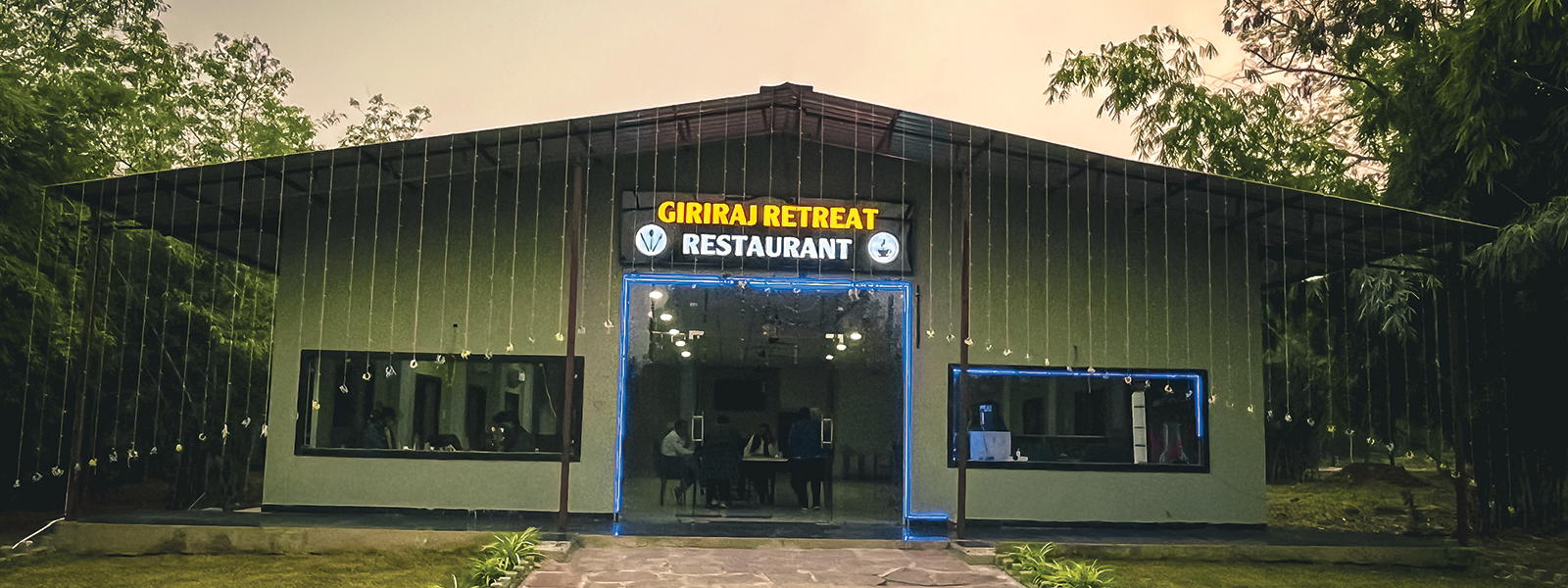 Cozy outdoor seating area with rustic wooden tables and string lights