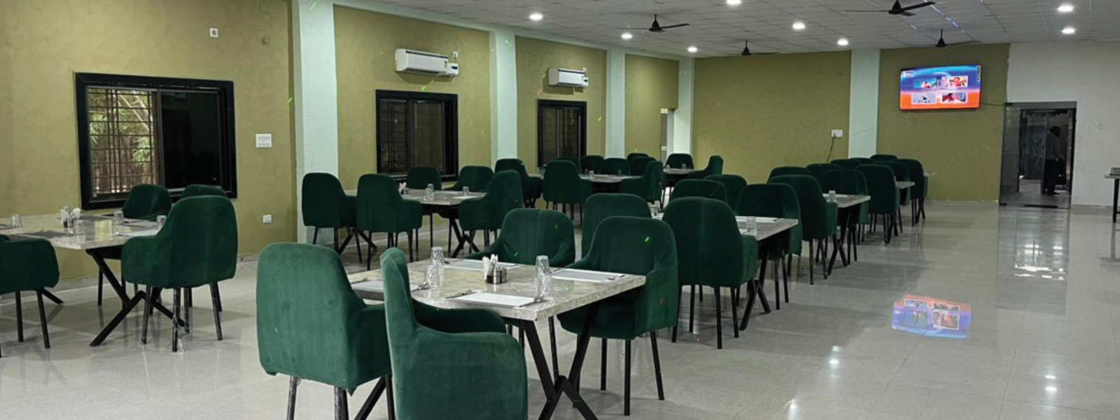 Barista pouring latte art into ceramic cup